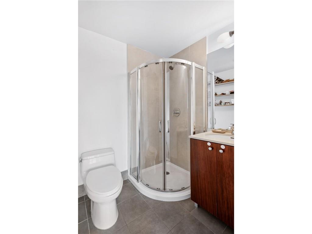 355 Stratford Road, Unit 5C Brooklyn, NY 11218 - Photo 5 of 12 a bathroom with a toilet a sink and shower