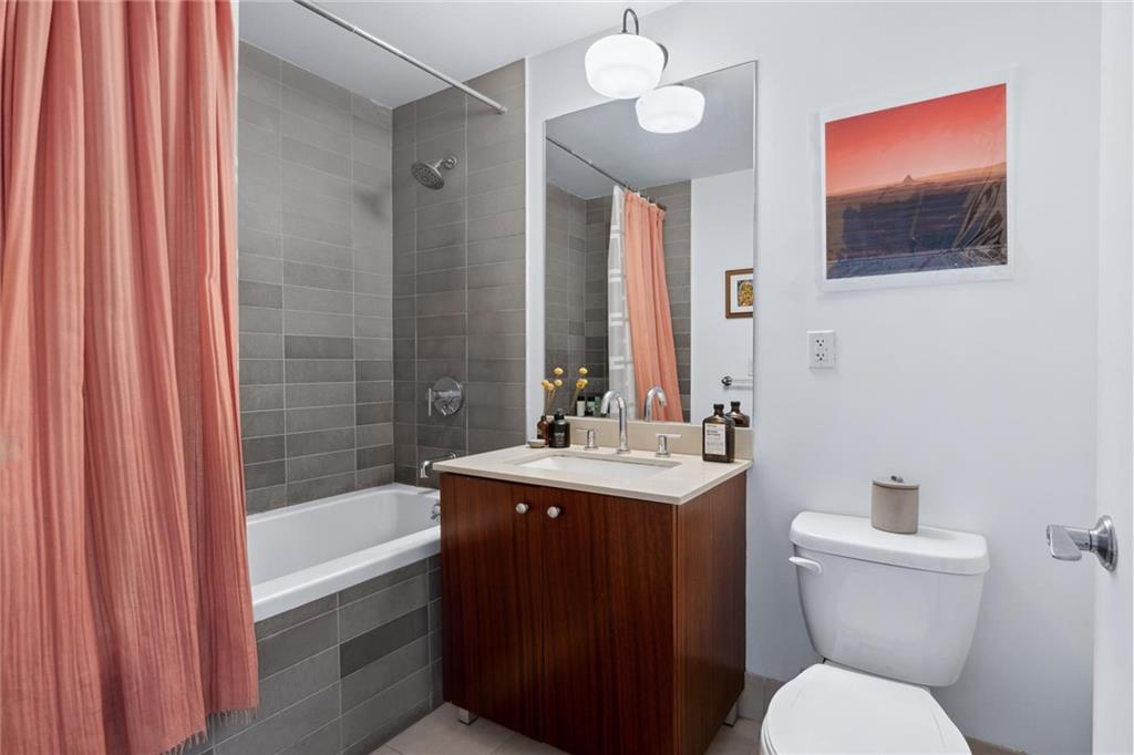 355 Stratford Road, Unit 5C Brooklyn, NY 11218 - Photo 7 of 12 a bathroom with a sink a toilet and shower