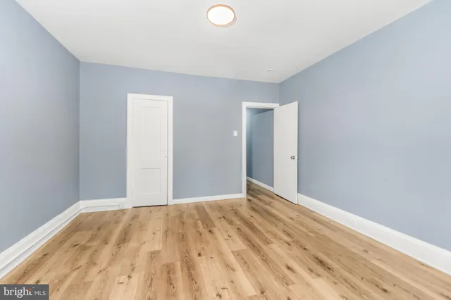 a view of a room with wooden floor and white walls