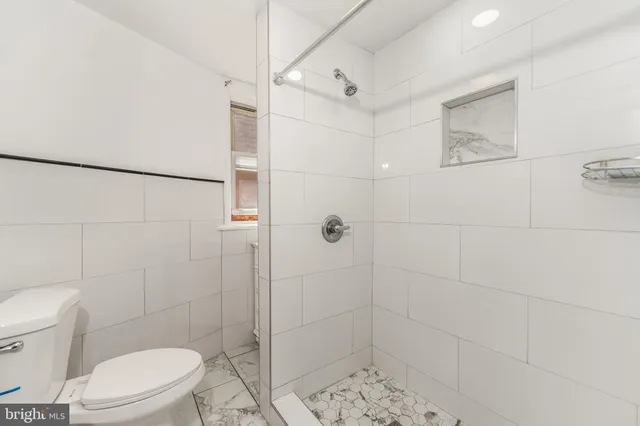 a bathroom with a toilet and shower