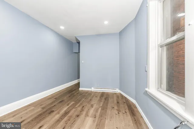 a view of room with window and wooden floor