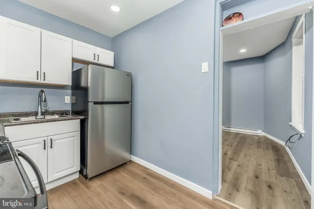 a kitchen with a refrigerator and a sink