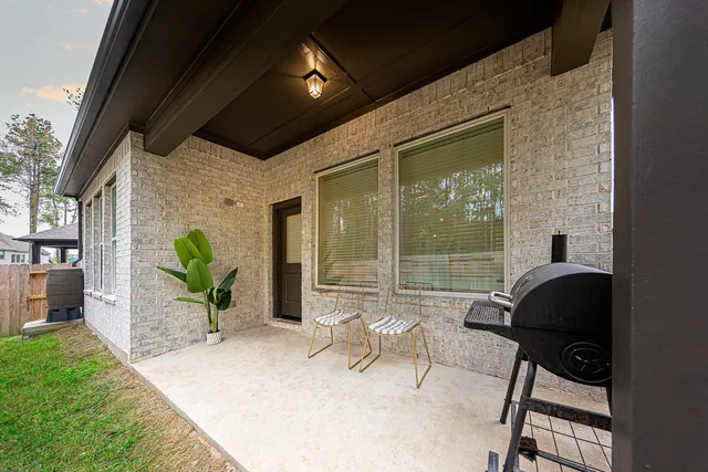 a living room filled with furniture and a floor to ceiling window