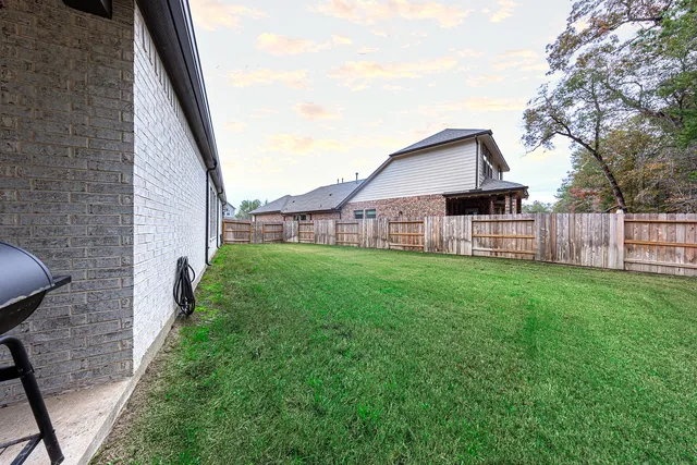 a view of a house with a backyard