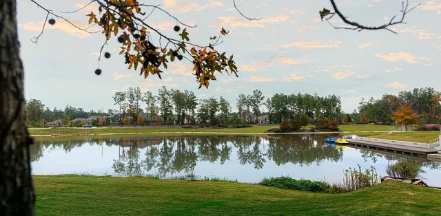 a view of a lake with houses in the back