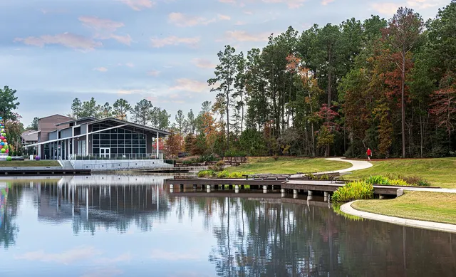 a view of a building with a yard and fountain