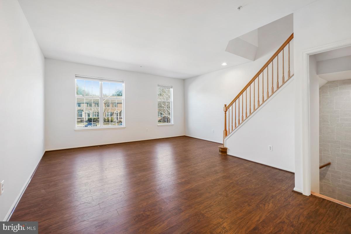 6334 Wind Rider Way Columbia, MD 21045 - Photo 13 of 45 a view of an empty room with wooden floor and a window
