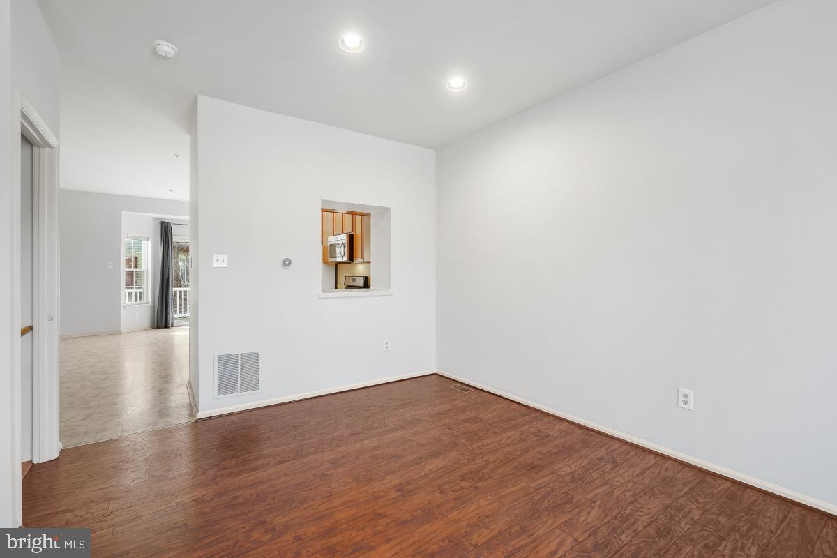 6334 Wind Rider Way Columbia, MD 21045 - Photo 16 of 45 an empty room with wooden floor and windows