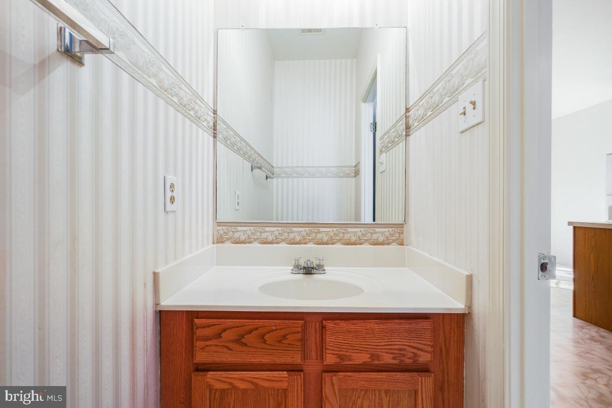 6334 Wind Rider Way Columbia, MD 21045 - Photo 18 of 45 a bathroom with a sink and a mirror