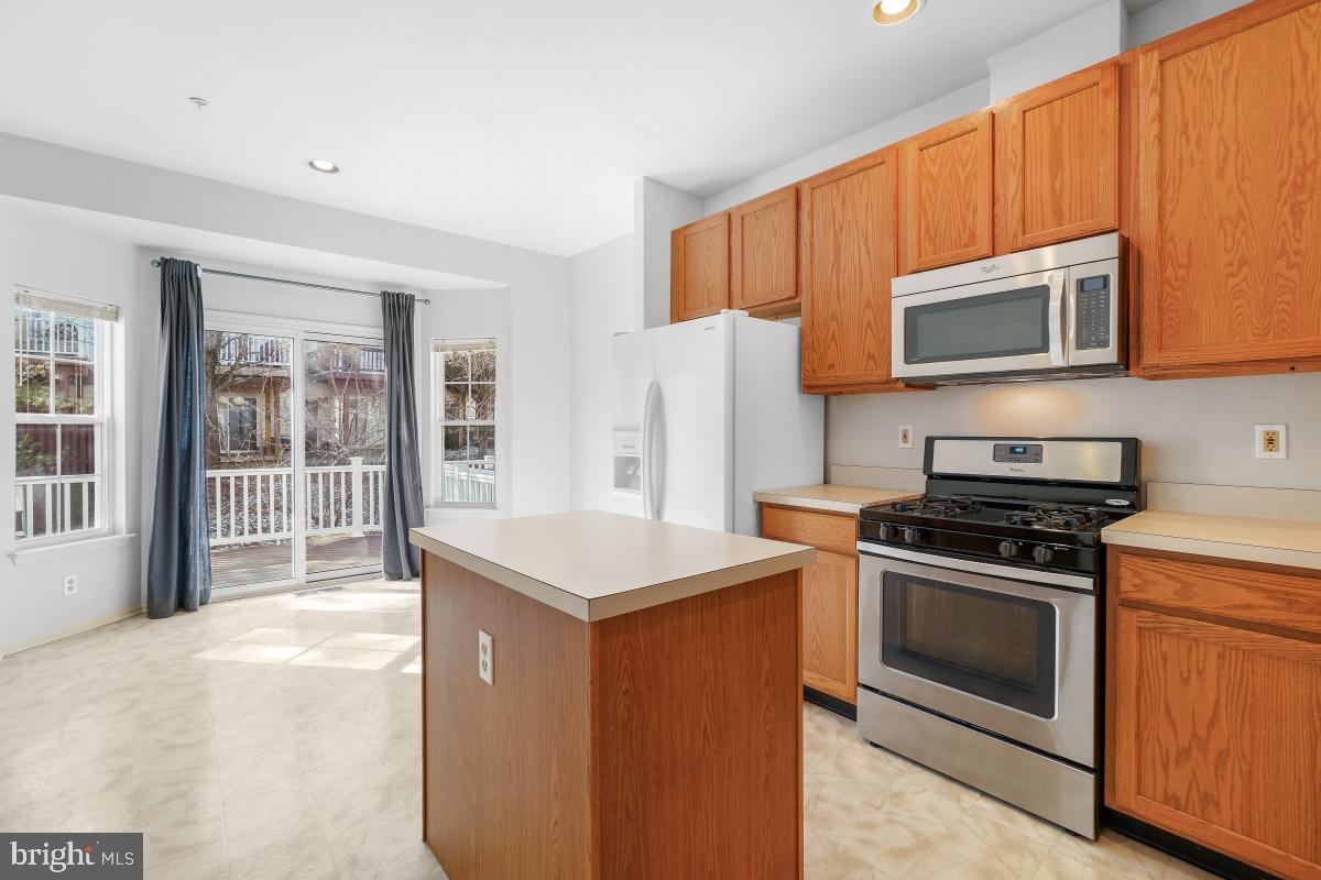 6334 Wind Rider Way Columbia, MD 21045 - Photo 25 of 45 a kitchen with a stove a sink and a microwave