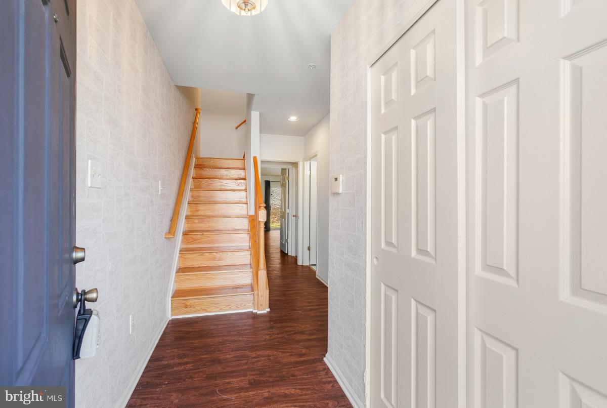 6334 Wind Rider Way Columbia, MD 21045 - Photo 3 of 45 a view of a hallway with wooden floor and entryway