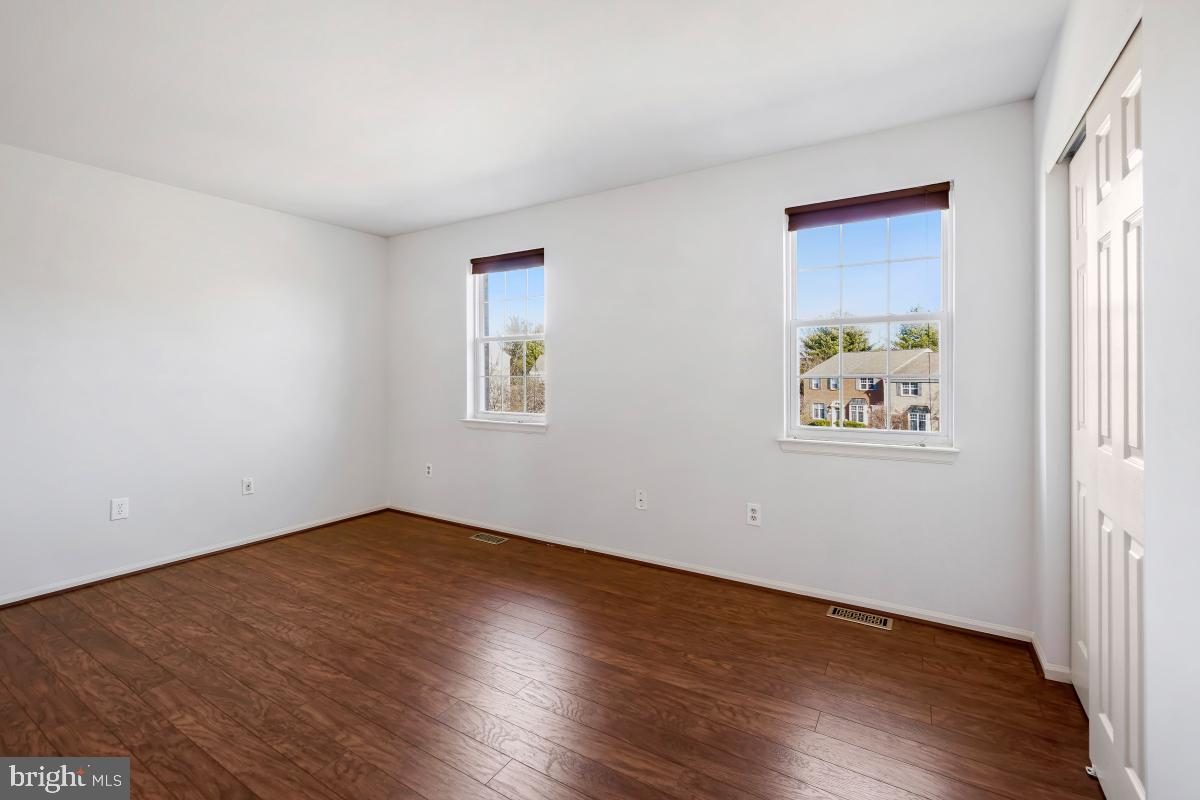 6334 Wind Rider Way Columbia, MD 21045 - Photo 38 of 45 an empty room with wooden floor and window