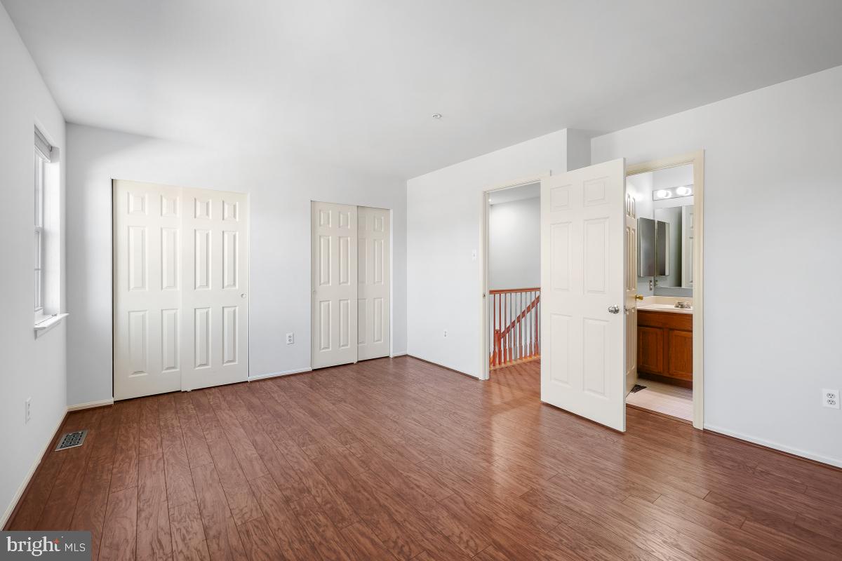 6334 Wind Rider Way Columbia, MD 21045 - Photo 40 of 45 a view of a big room with wooden floor and windows