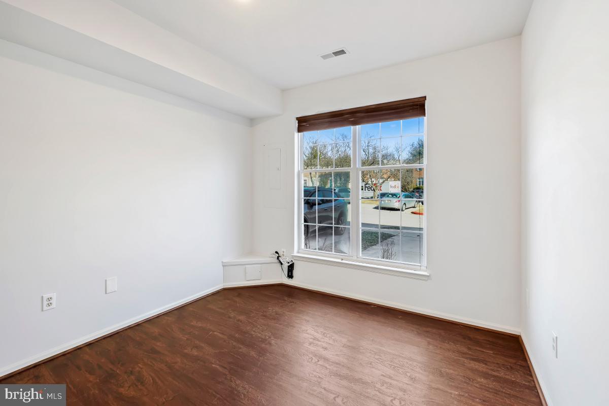 6334 Wind Rider Way Columbia, MD 21045 - Photo 6 of 45 an empty room with wooden floor and windows