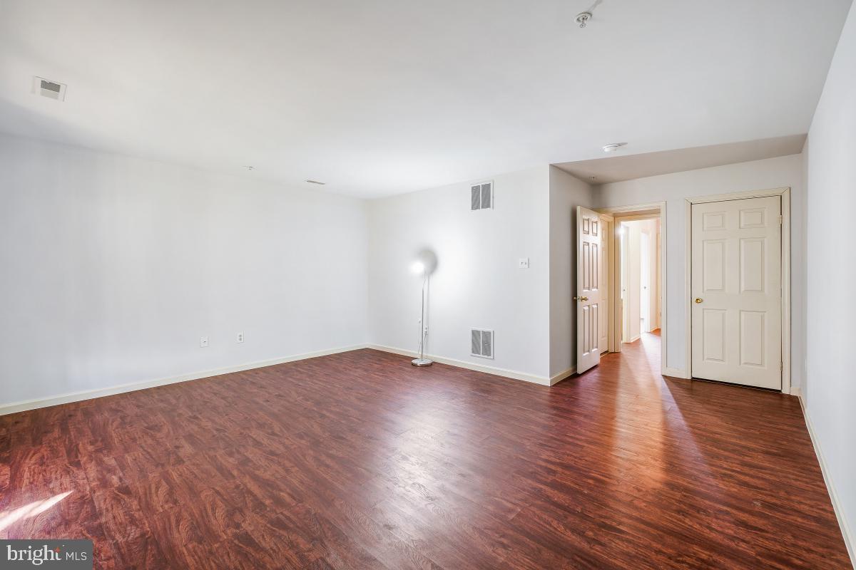 6334 Wind Rider Way Columbia, MD 21045 - Photo 10 of 45 an empty room with wooden floor & windows