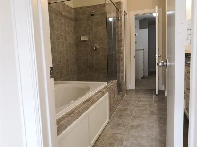 a bathroom with a tub and shower