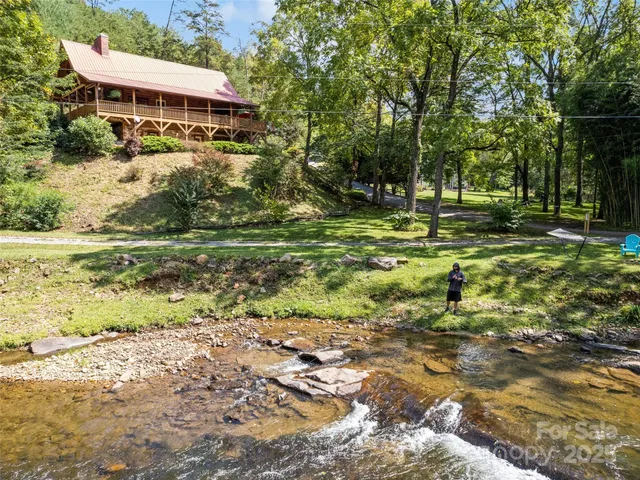 a view of a house with a yard and sitting area