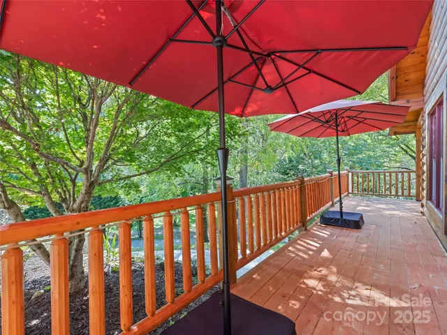 a view of a patio with a table and chairs under an umbrella