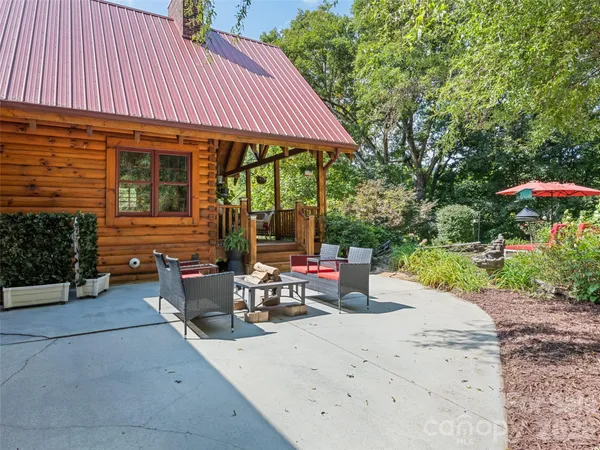 a patio with a table and chairs under an umbrella