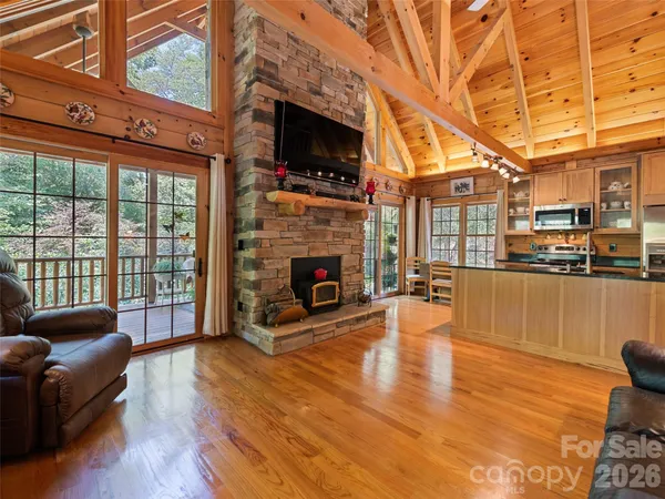 a living room with furniture wooden floor and a fireplace
