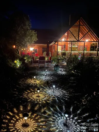a view of a house with a yard fire pit and outdoor seating