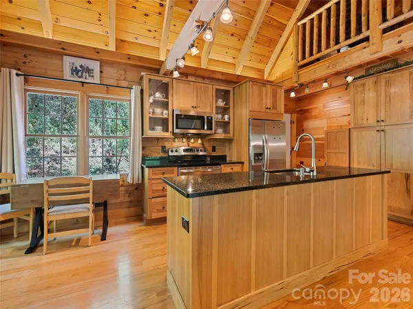 a kitchen with stainless steel appliances granite countertop a sink and cabinets