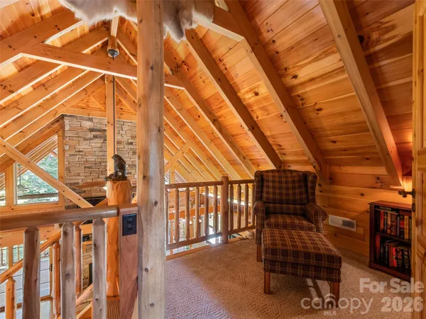 a view of a chairs and bench in the roof deck