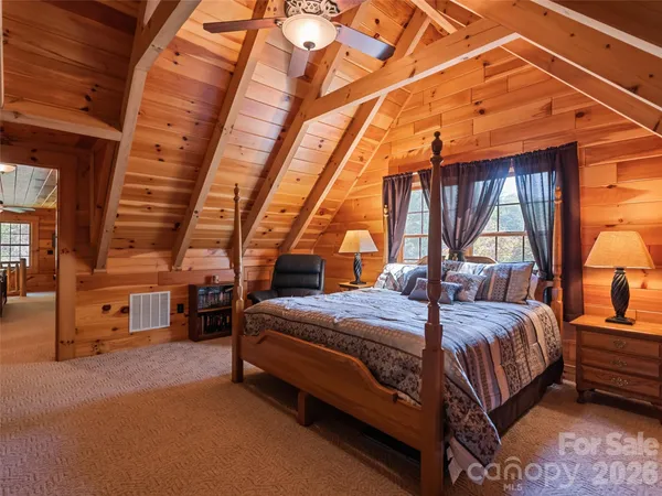 a bed room with a bed and a chair