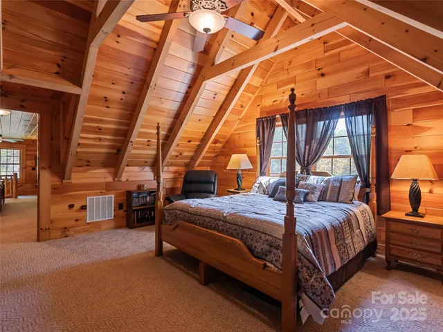 a bed room with a bed and a chair