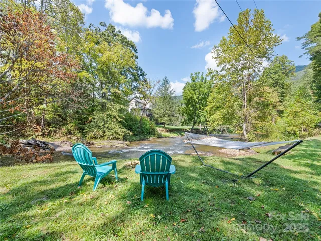 a backyard of a house with table and chairs
