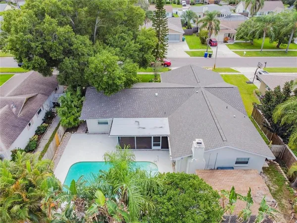 an aerial view of a house with a yard and lake view
