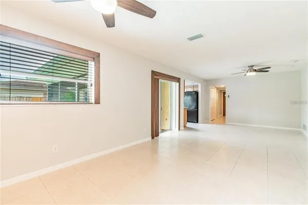 a view of empty room with wooden floor and windows