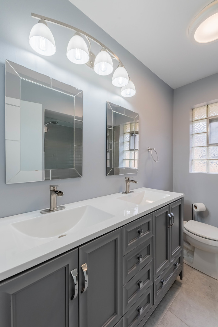 8000 Country Club Lane North Riverside, IL 60546 - Photo 18 of 41 a bathroom with a granite countertop sink a toilet and a mirror