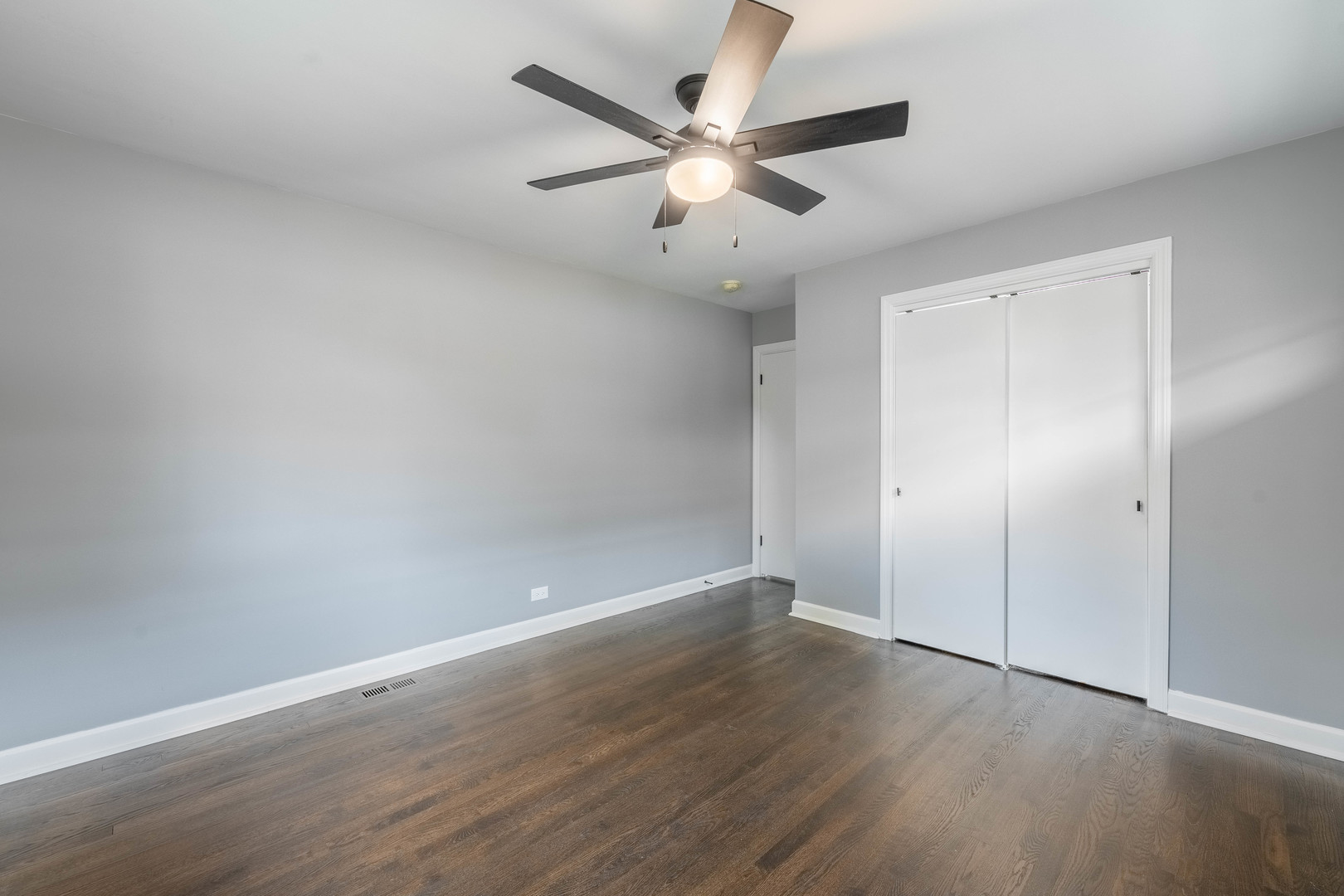 8000 Country Club Lane North Riverside, IL 60546 - Photo 22 of 41 an empty room with wooden floor and ceiling fan