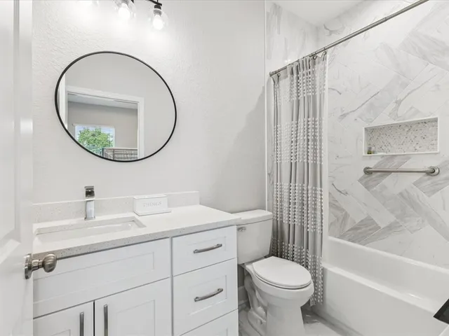 a bathroom with a sink toilet and a mirror