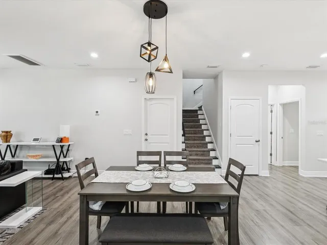 a view of a dining room with furniture and wooden floor