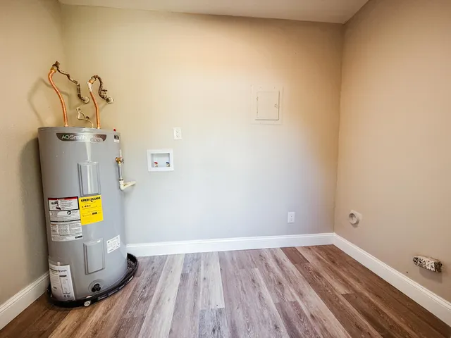 a view of a room with wooden floor and a sink