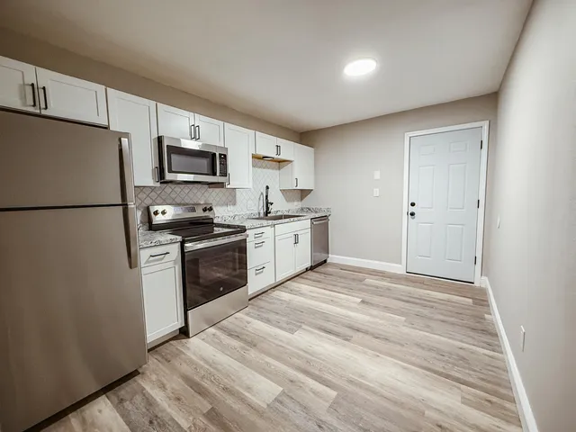 a kitchen with a refrigerator stove and microwave