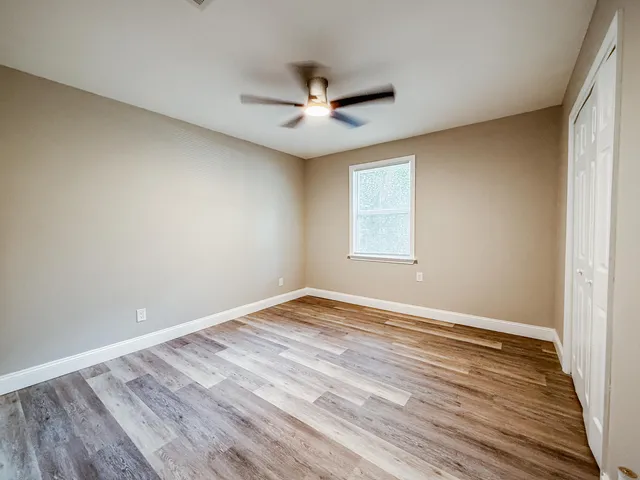 wooden floor in an empty room with a window