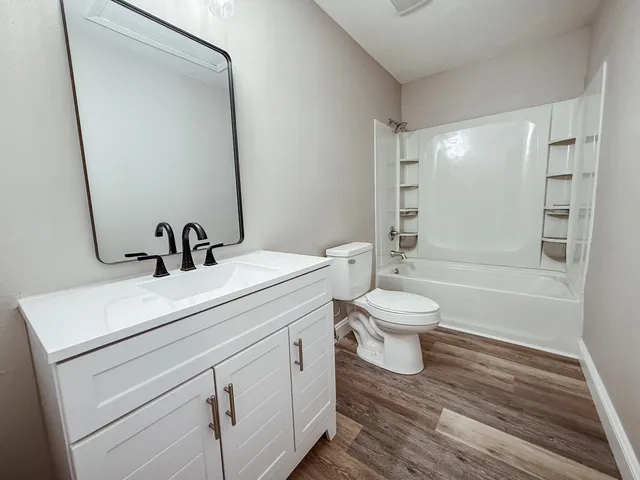 a bathroom with a toilet a sink and a mirror