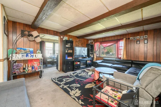 a room with lots of furniture and a flat screen tv
