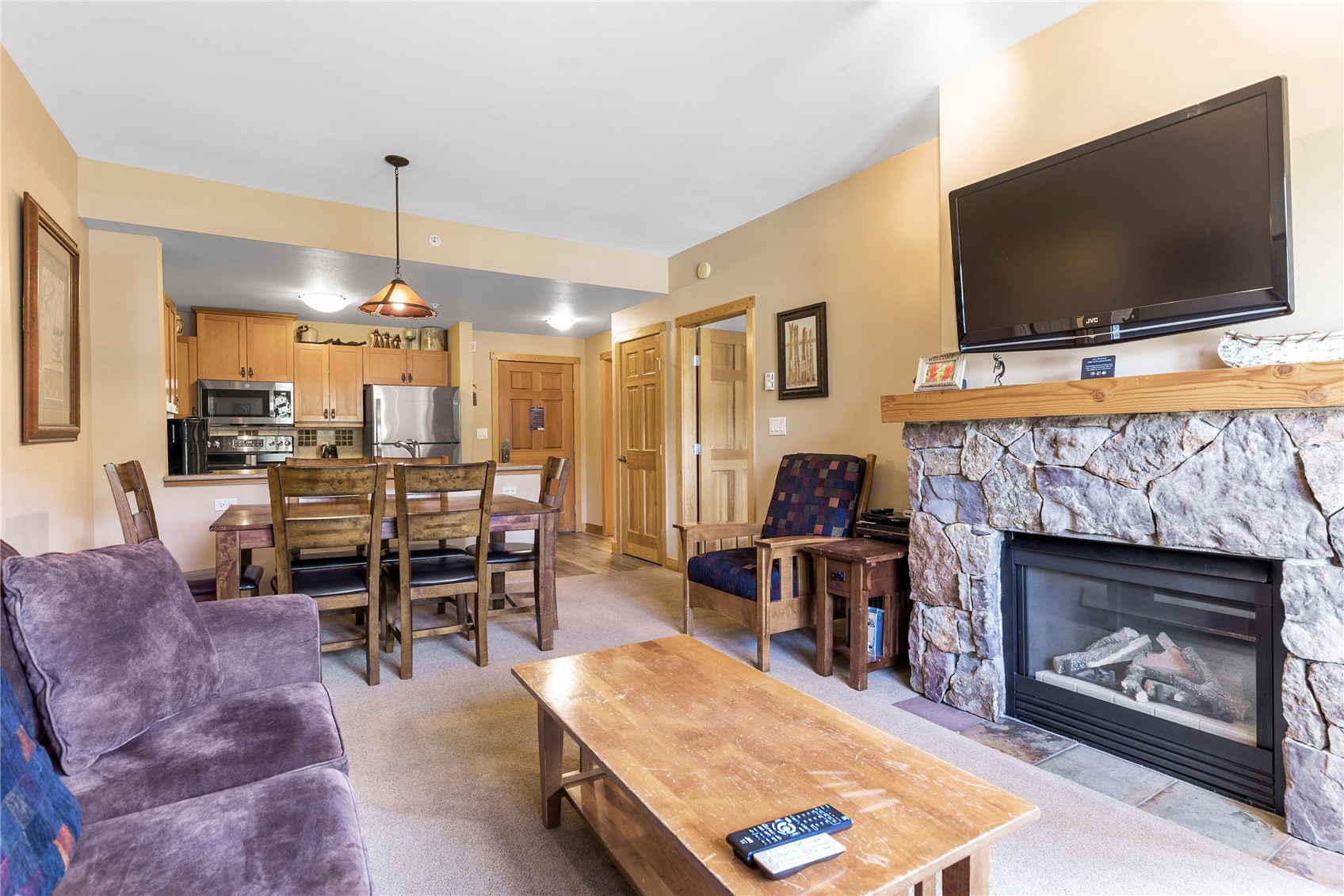 910 Copper Road, Unit 219 Copper Mountain, CO 80443 - Photo 3 of 35 a living room with furniture a flat screen tv and a fireplace