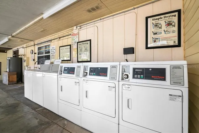 a kitchen with stainless steel appliances granite countertop white cabinets and white appliances