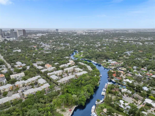 an aerial view of city with green space