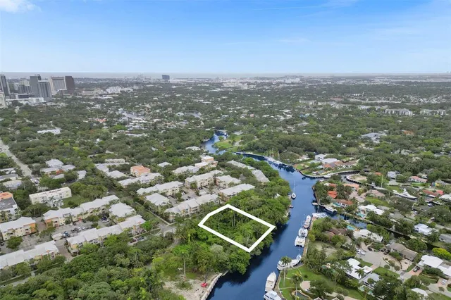 an aerial view of residential houses with city view