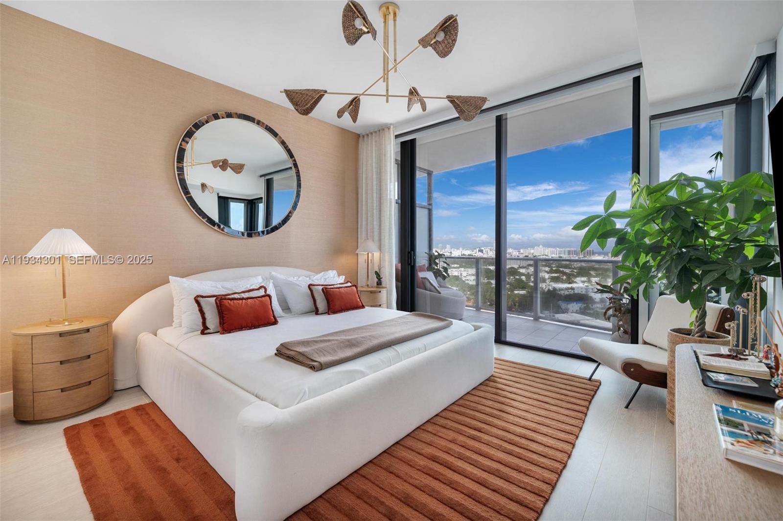 500 Alton Road, Unit 1602 Miami Beach, FL 33139 - Photo 9 of 33 a bed room with a bed mirror and a large window