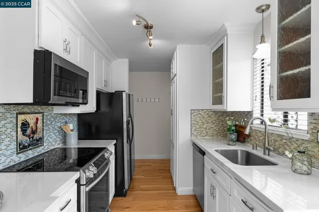 an empty room with a window and a ceiling fan
