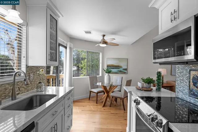 a backyard of a house with lots of green space and wooden fence