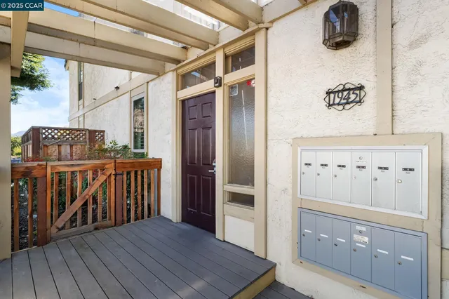 a living room with furniture a potted plant and a fireplace