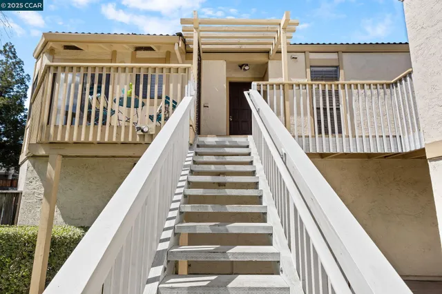 a living room with furniture a wooden floor and a large window